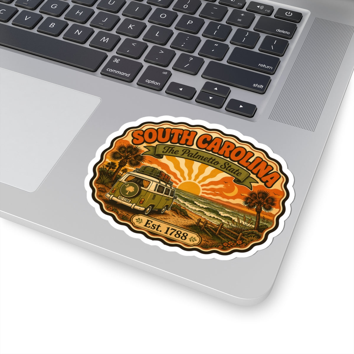 Laptop sticker featuring South Carolina text, camper scene, palm trees, and Est. 1788.