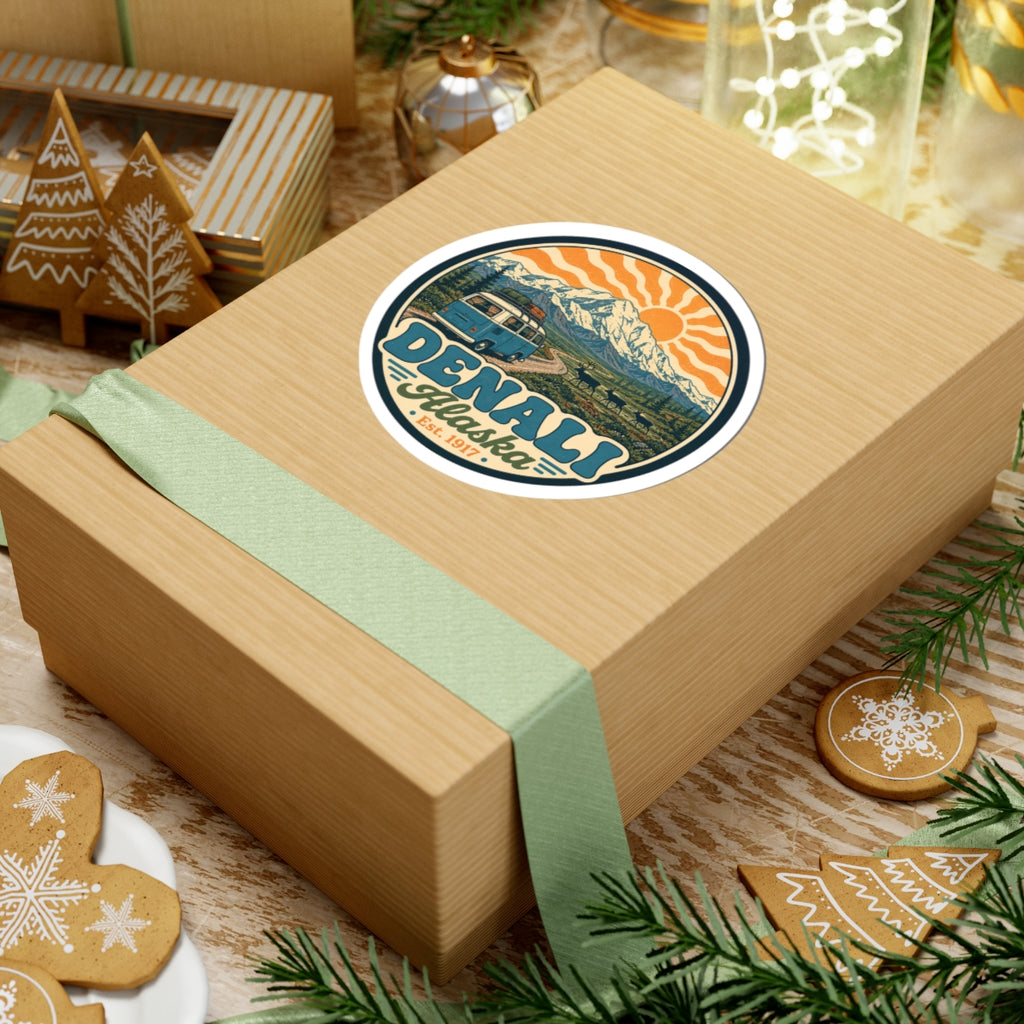 Circular outdoor sticker on a wooden gift, Denali Alaska text with mountain and teal van