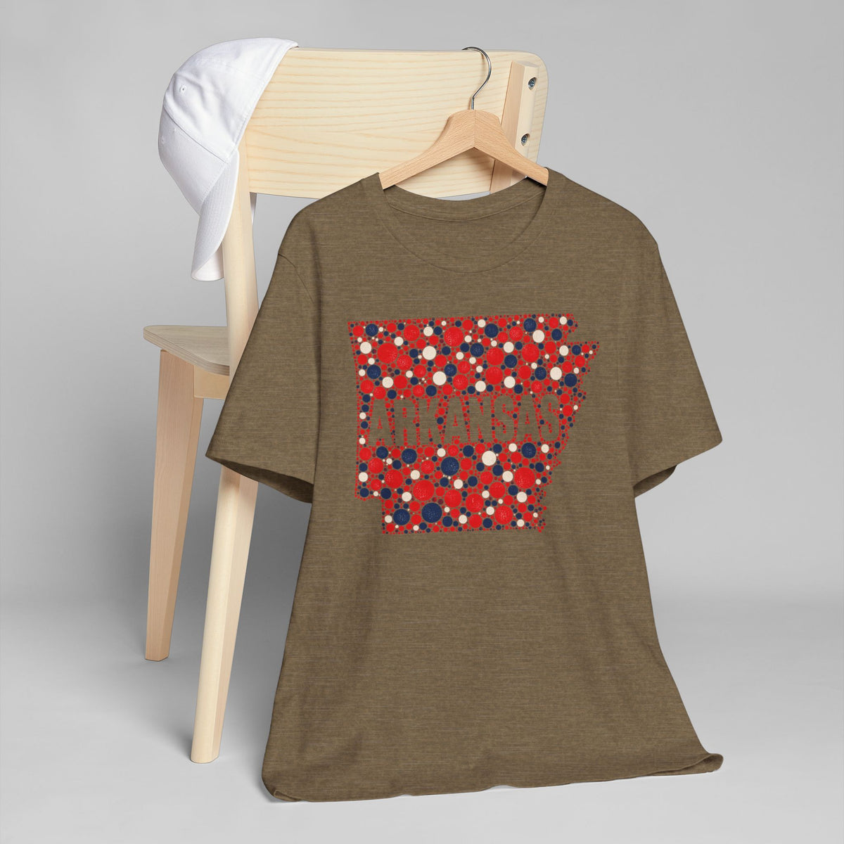 Brown crew-neck T-shirt with red, white, and blue Arkansas floral dot graphic.