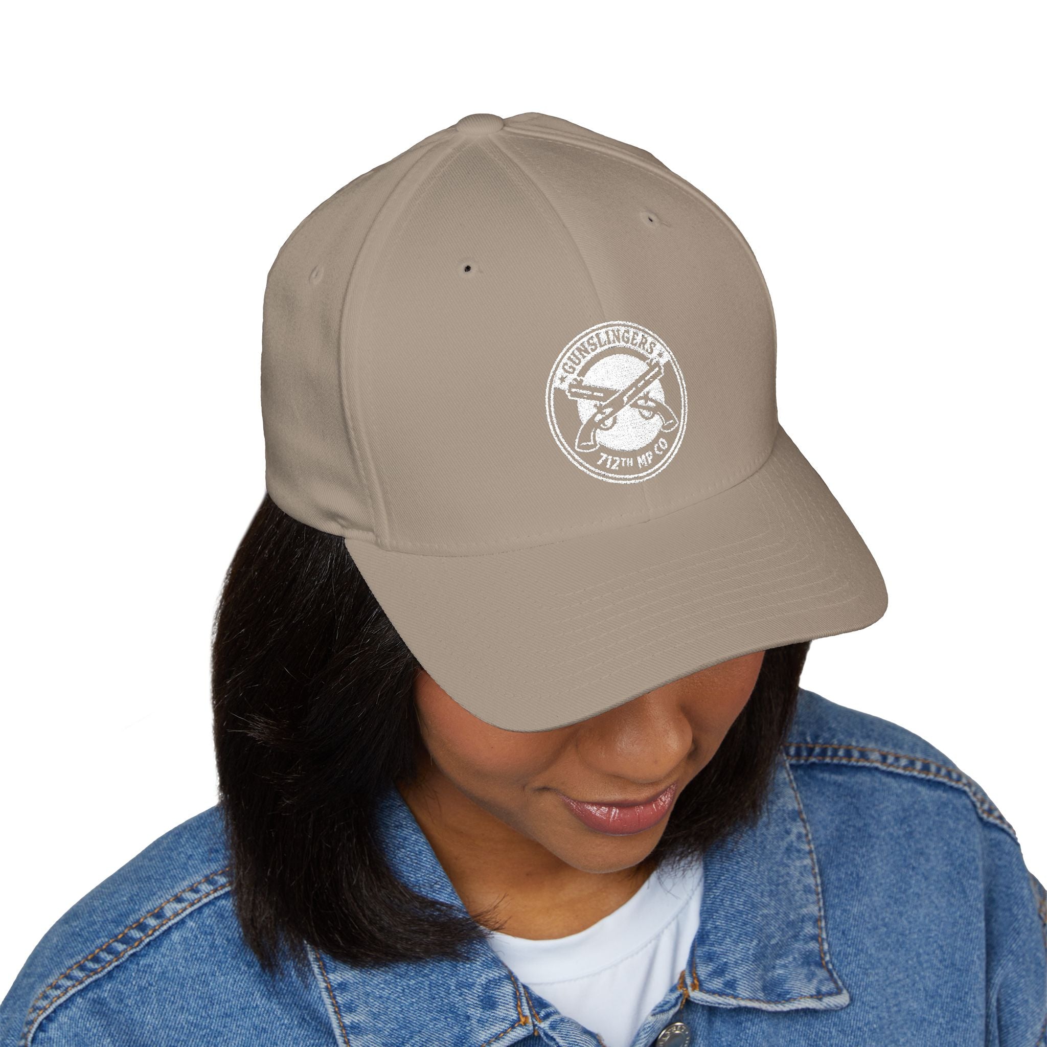 Embroidered baseball cap in khaki with white circular emblem on front panel.