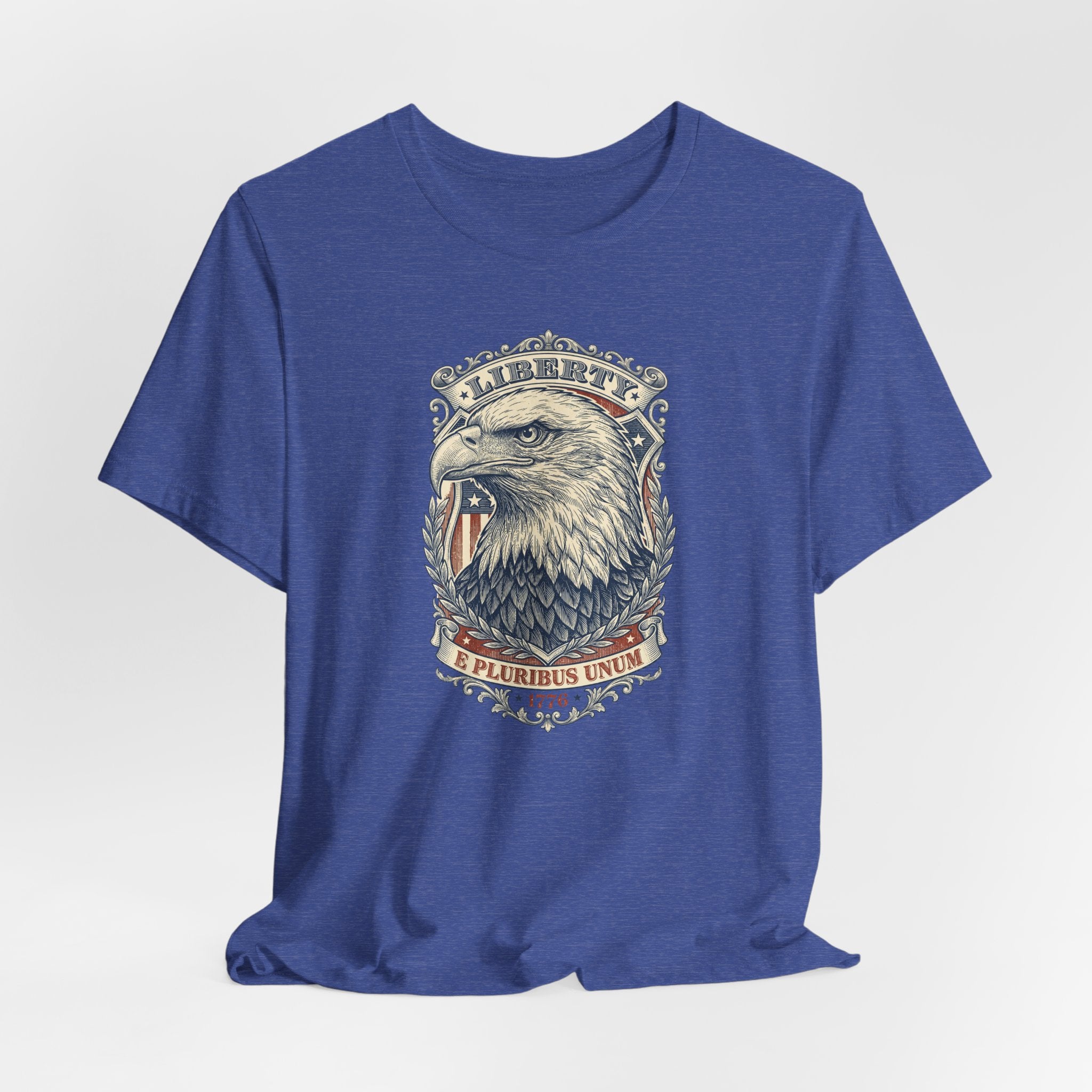 Blue crewneck t-shirt with eagle head graphic and emblem at center front.