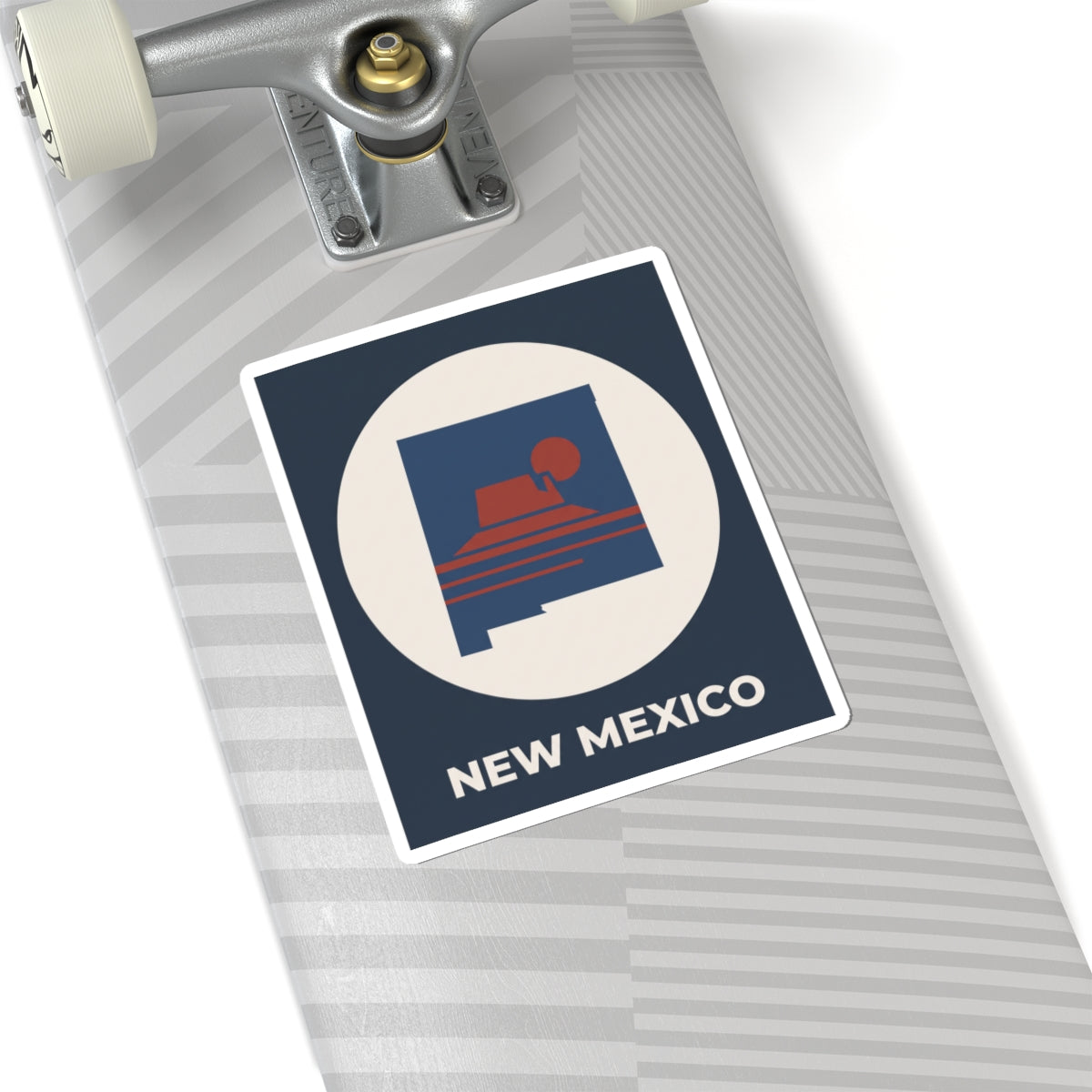 Tilted New Mexico sunset kiss-cut sticker with dark blue square, white circle, and “NEW MEXICO”.