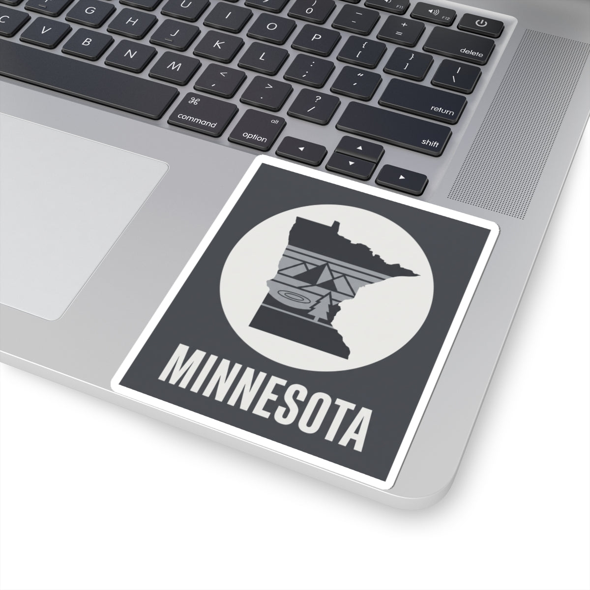 Minnesota logo kiss-cut sticker on laptop, showing circular icon and “MINNESOTA”