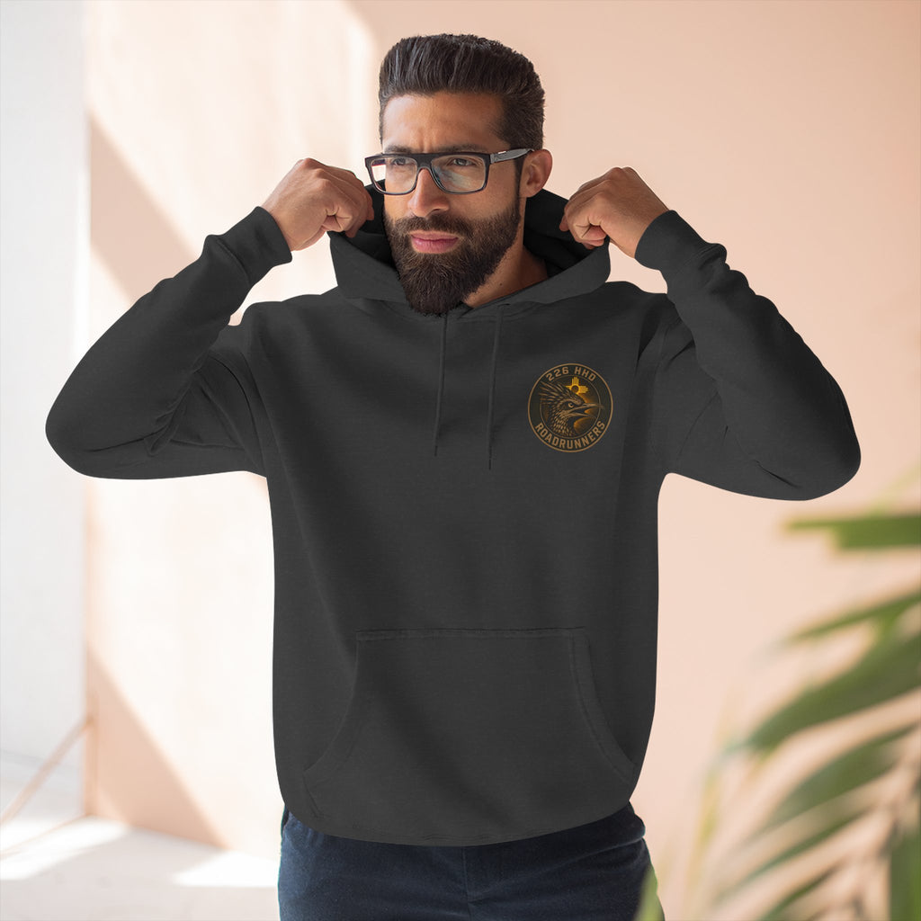 Black pullover hoodie with hood, drawstrings, and chest logo patch