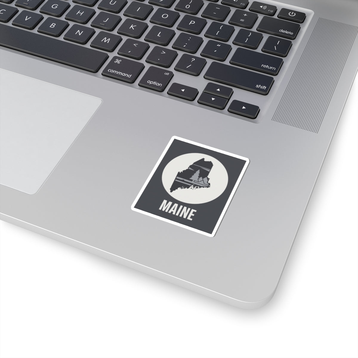 Maine state silhouette sticker with Maine text on a laptop