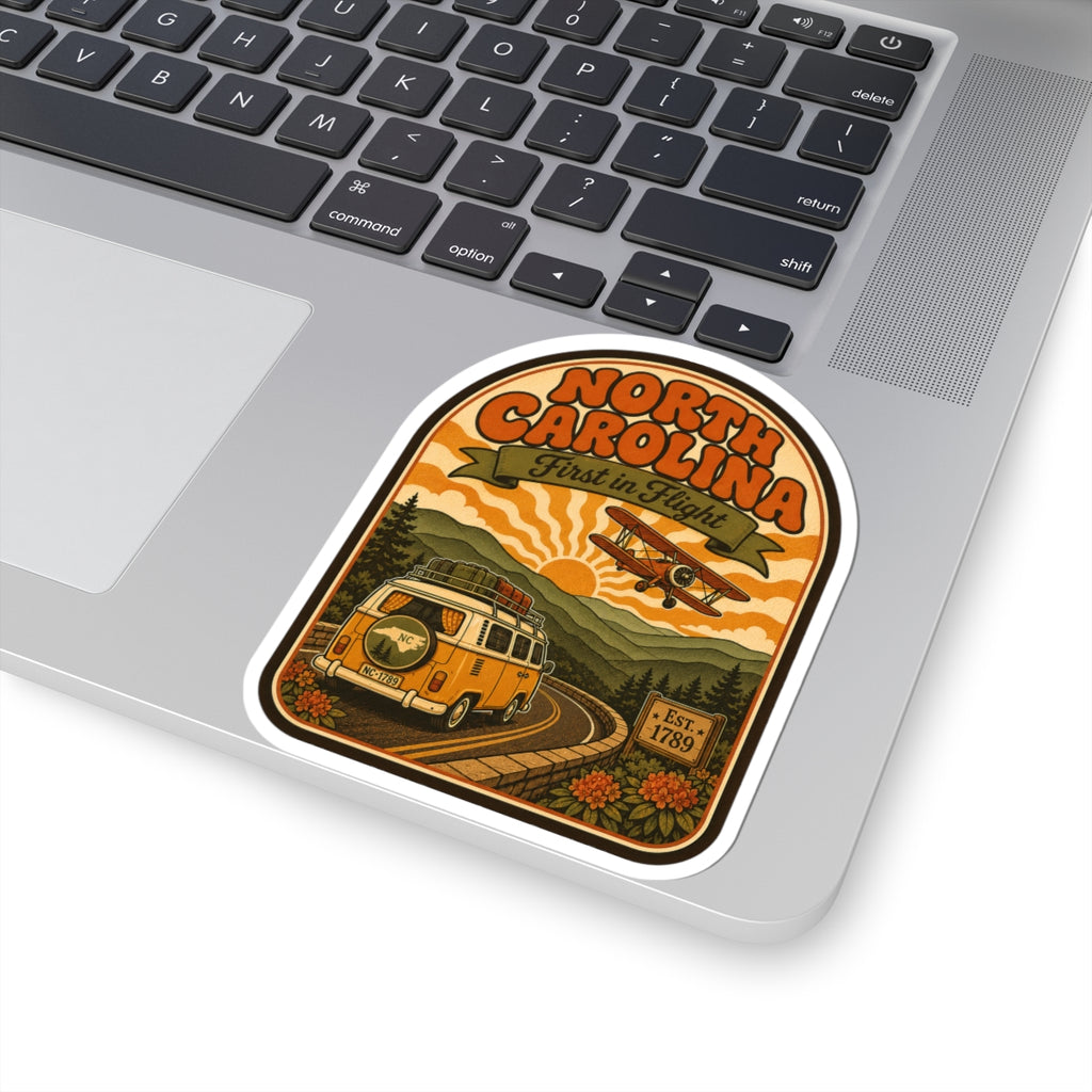 North Carolina “First in Flight” van and biplane sticker on laptop, white die-cut