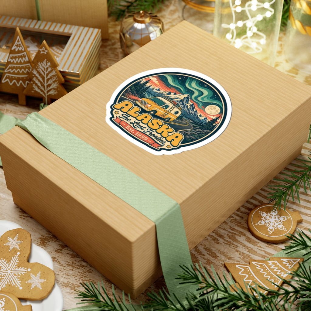 Kiss-cut sticker on a gift box lid with Alaska van scene and blue-green waves
