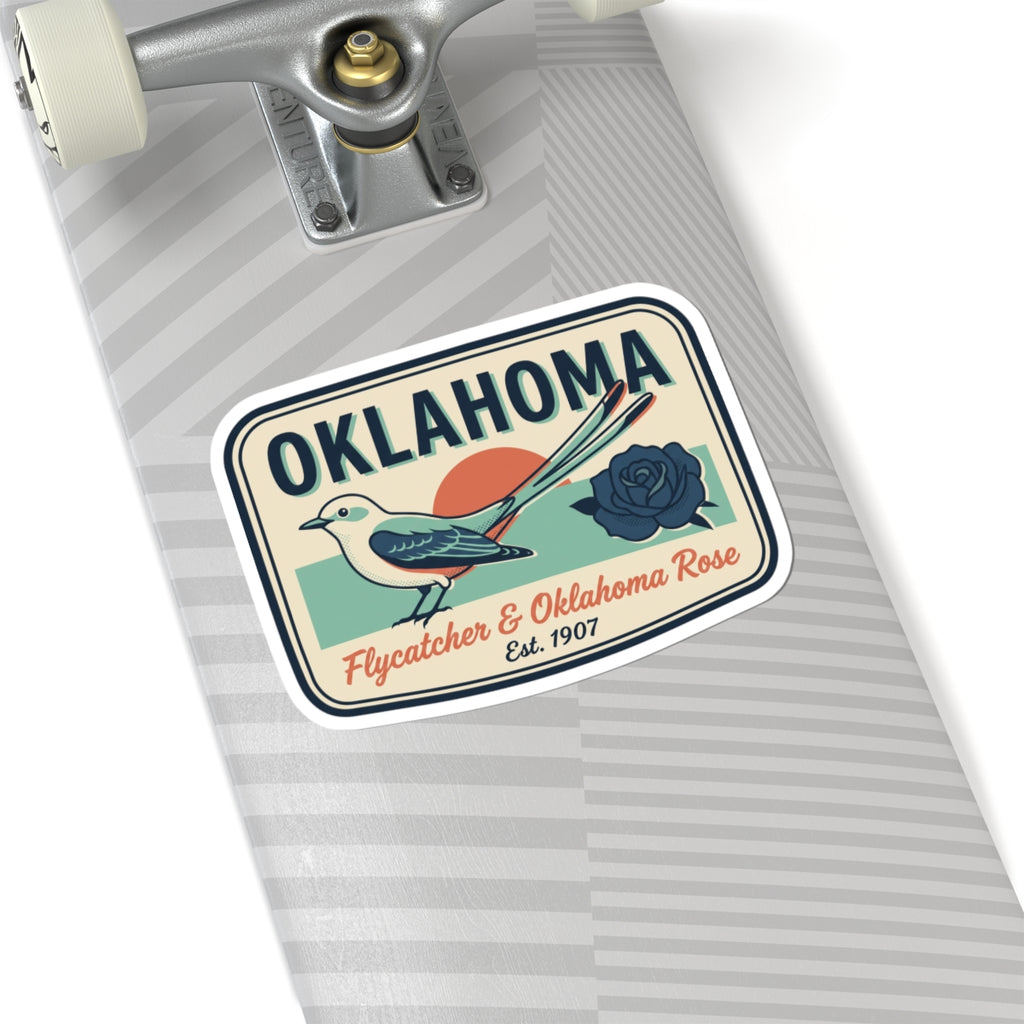 Oklahoma sticker on gray striped surface, bird and rose badge with white border
