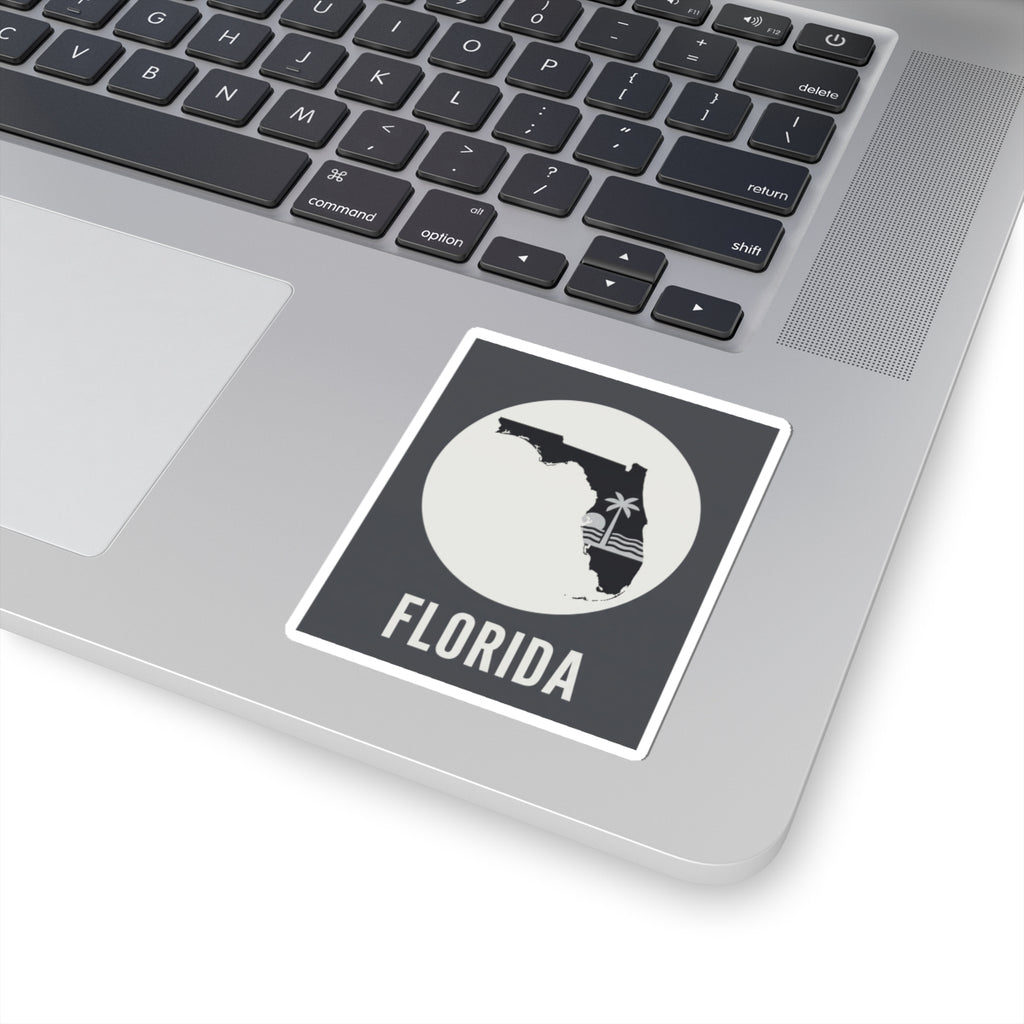 Florida silhouette kiss-cut sticker on laptop keyboard, circular palm wave and FLORIDA text