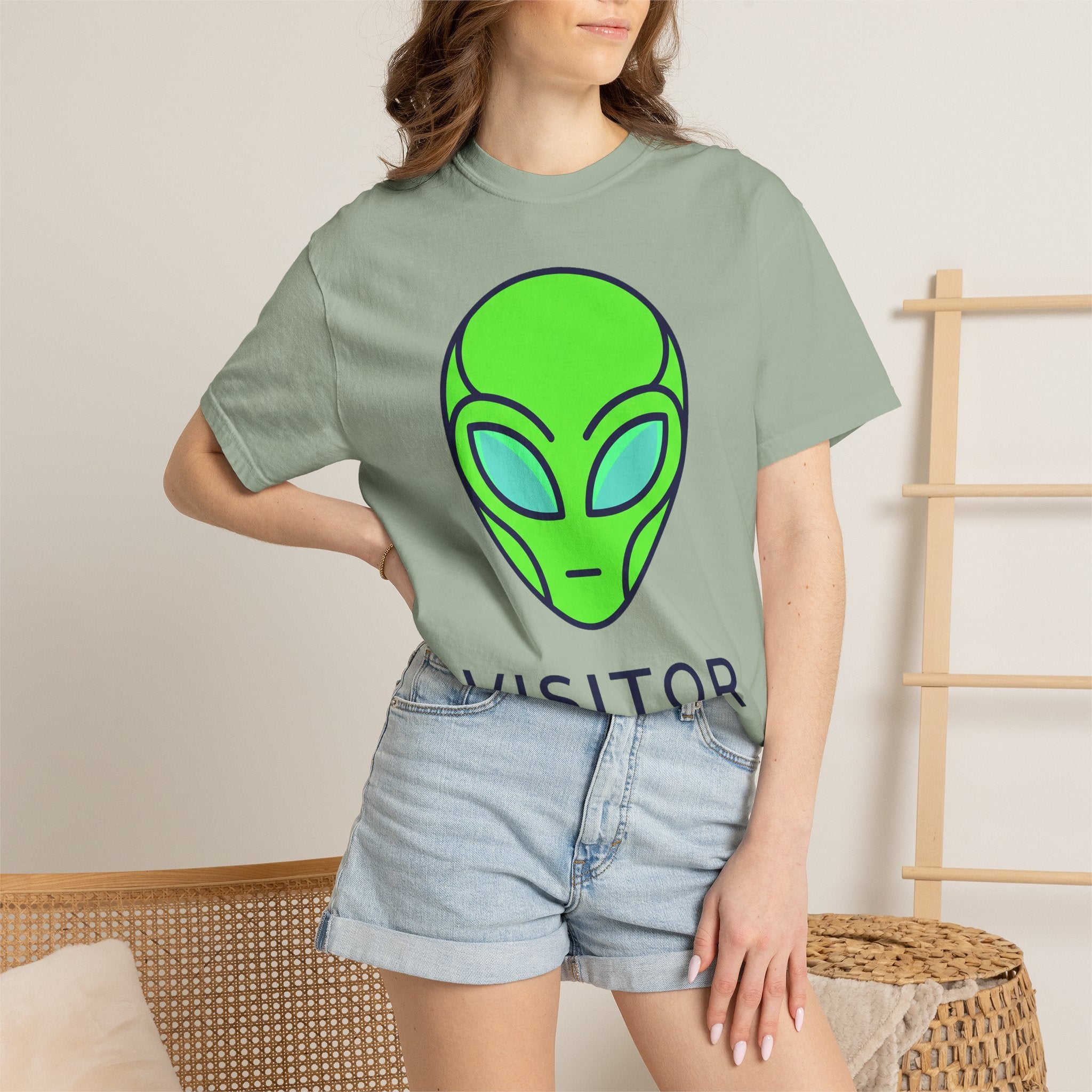 Sage green T-shirt with neon alien face graphic