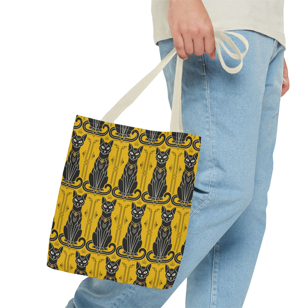 Yellow cat-pattern tote bag in hand with light beige handles and navy cat print