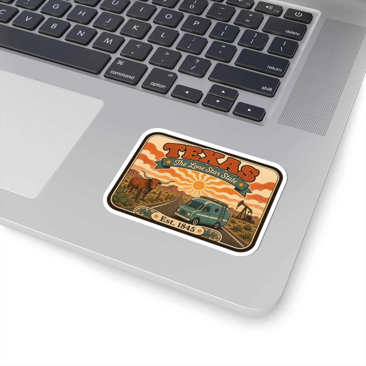 Texas travel sticker on laptop keyboard, retro van and Est. 1845