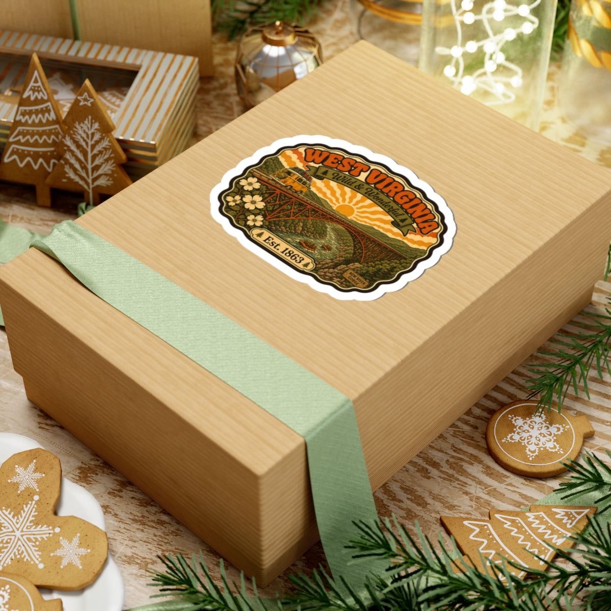 West Virginia kiss-cut sticker on a gift box, with bridge artwork, Wild & Wonderful banner, Est. 1863.