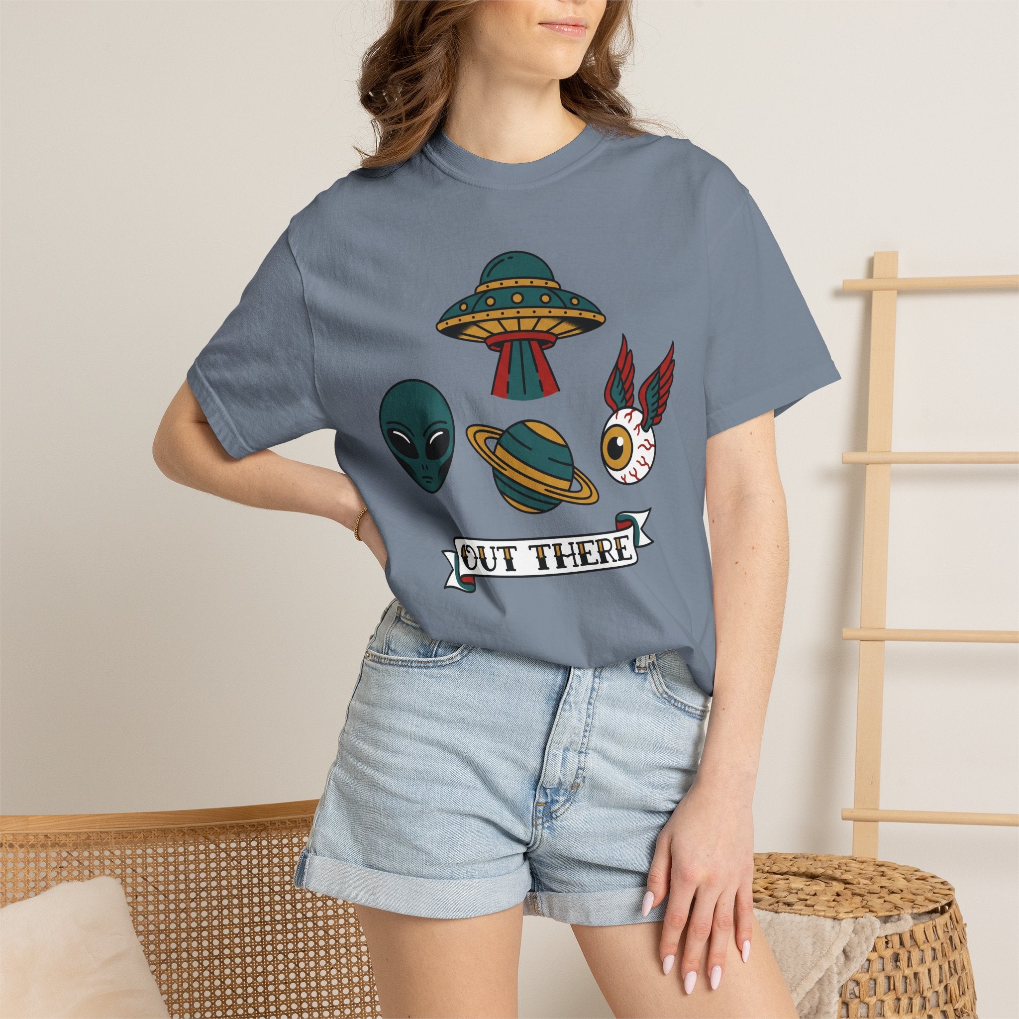 Light blue T-shirt with alien, UFO, cat graphic and 'OUT THERE' text