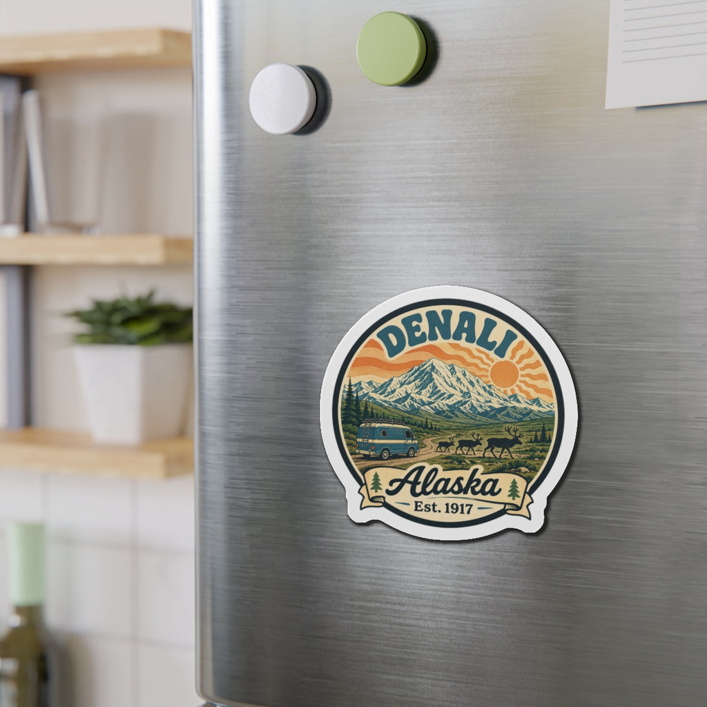 Round die-cut Denali Alaska fridge magnet with mountain, van, and wildlife design