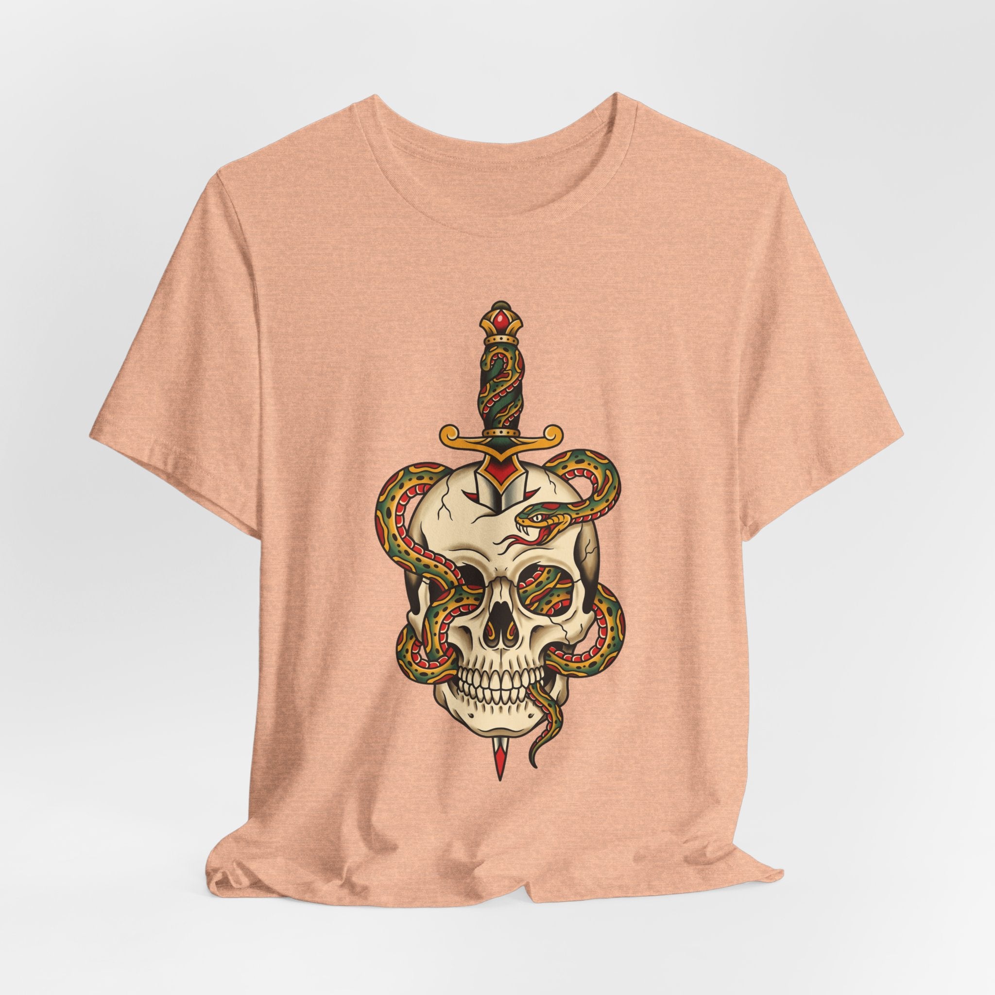 Peach T-shirt with large colorful snake skull and dagger graphic on front