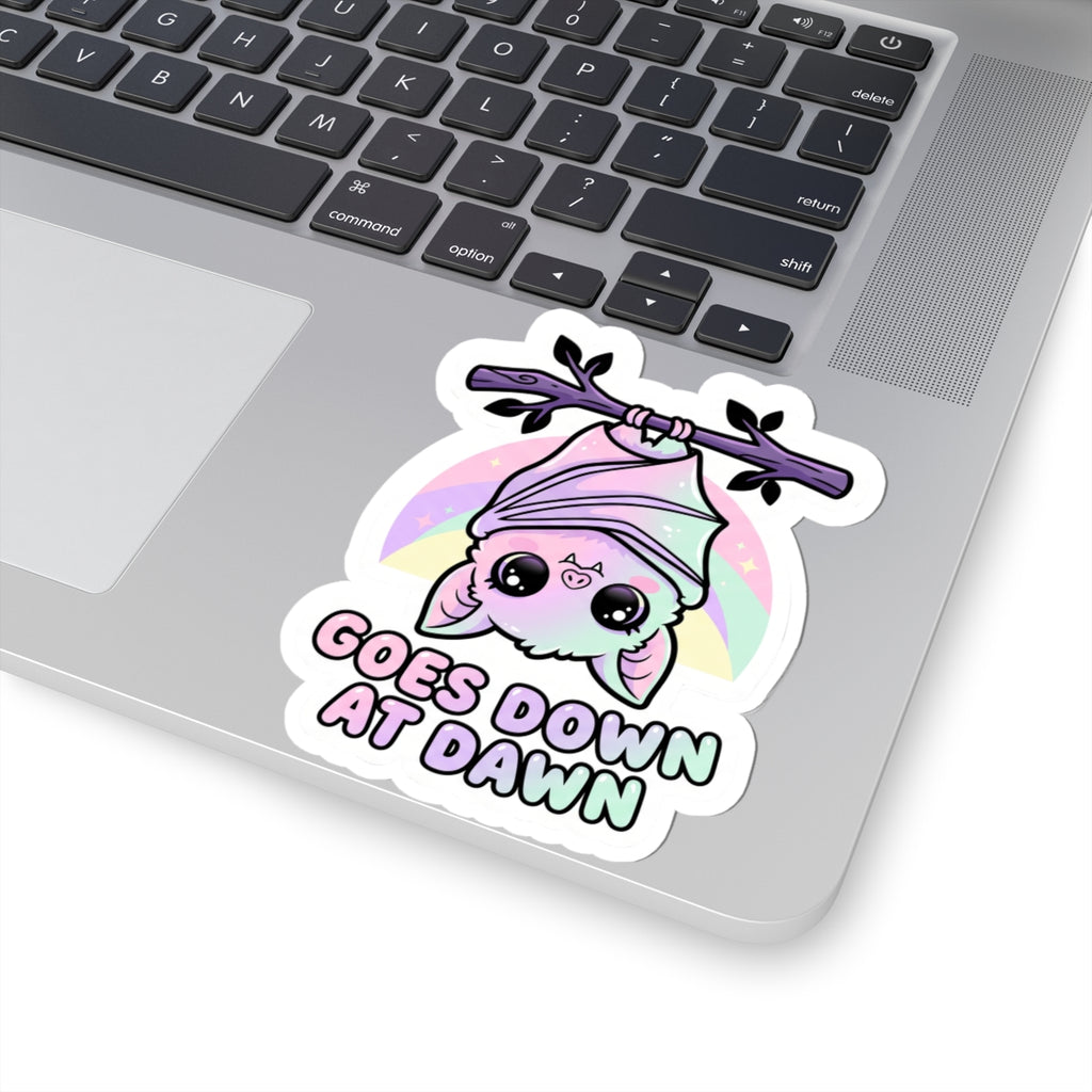 Kawaii kiss-cut vinyl sticker of purple bat character, pink hood, pastel circle, and "GOES DOWN AT DAWN"