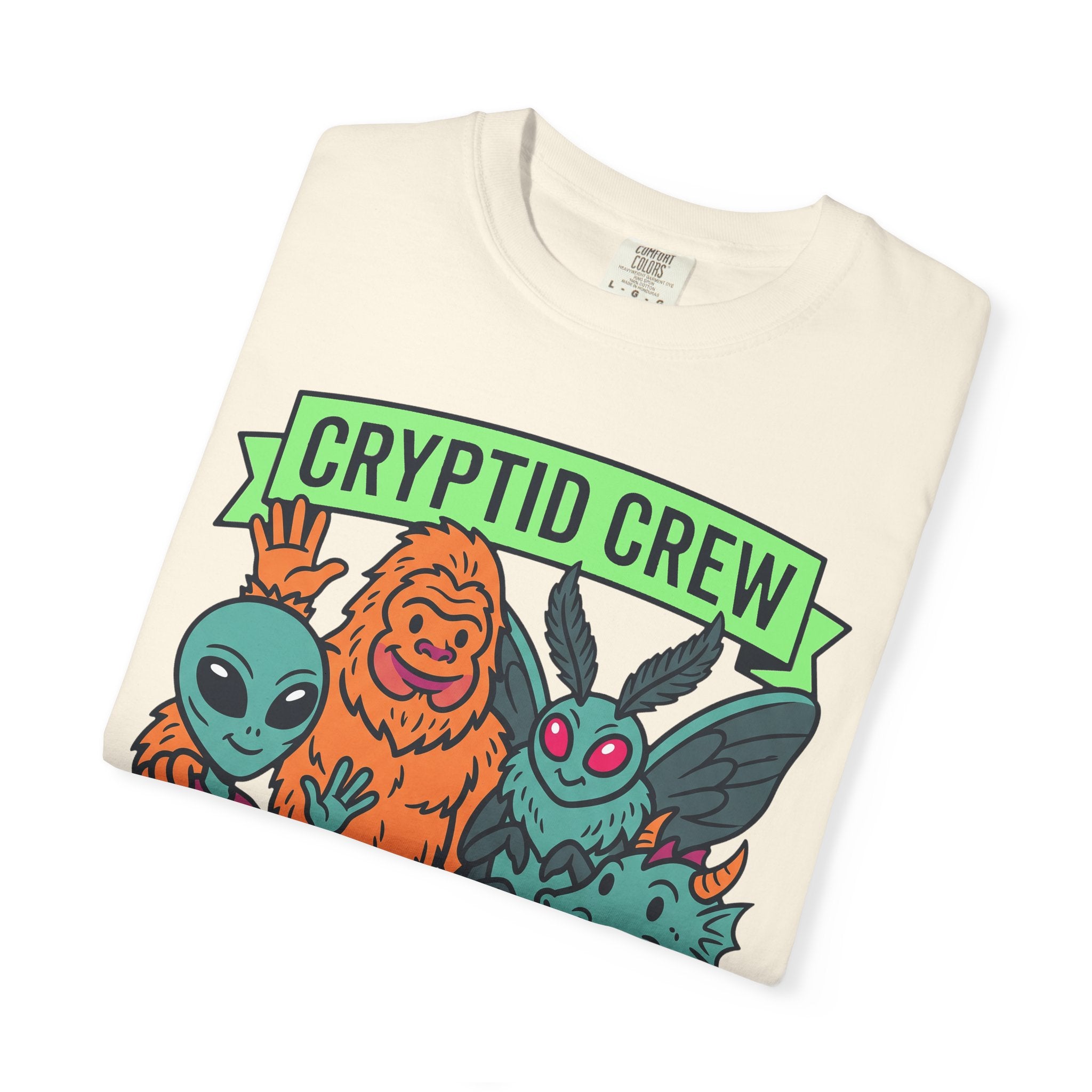 Ivory crew-neck T-shirt with “Cryptid Crew” graphic and four alien cryptids
