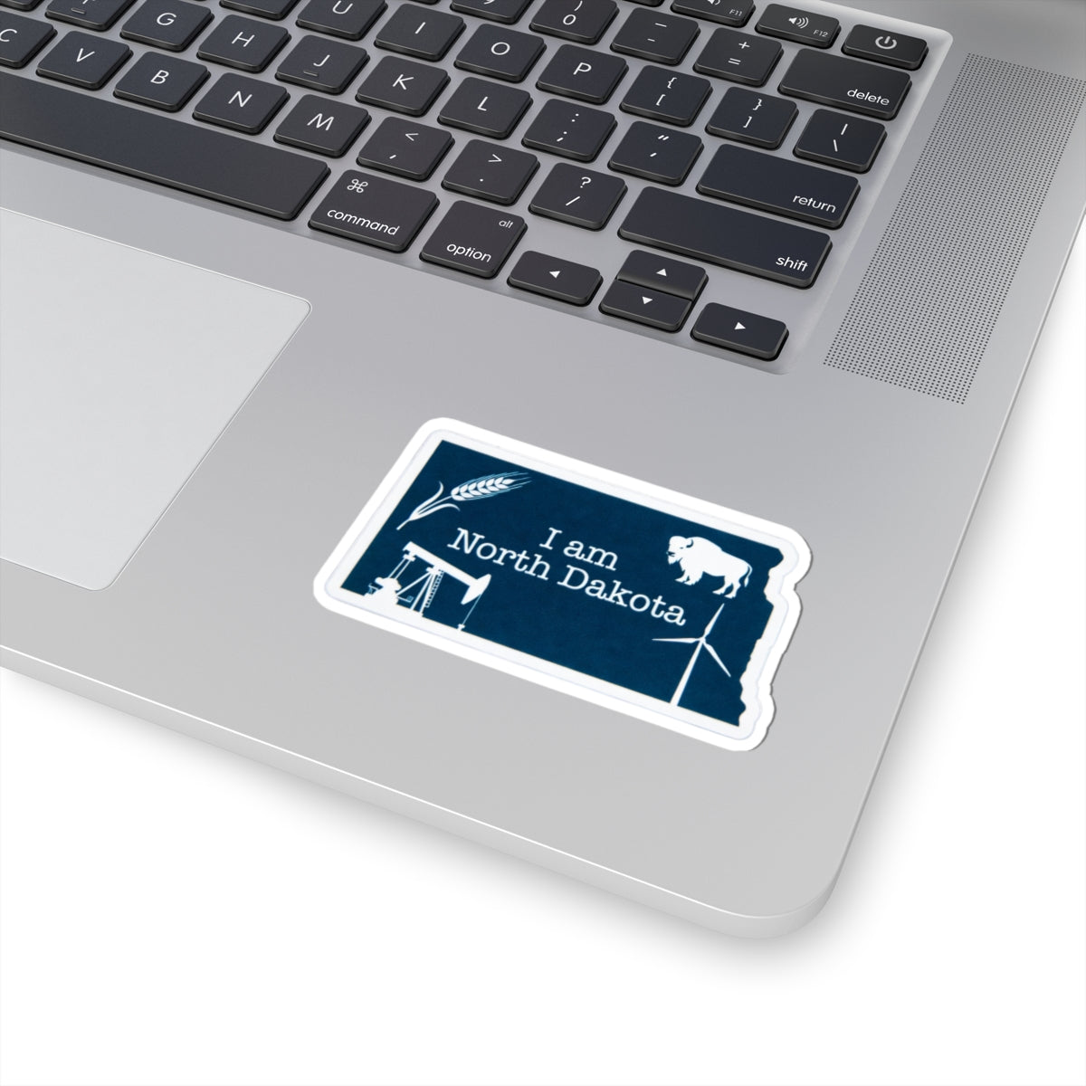Blue 'I am North Dakota' sticker on white border, buffalo and windmill icons