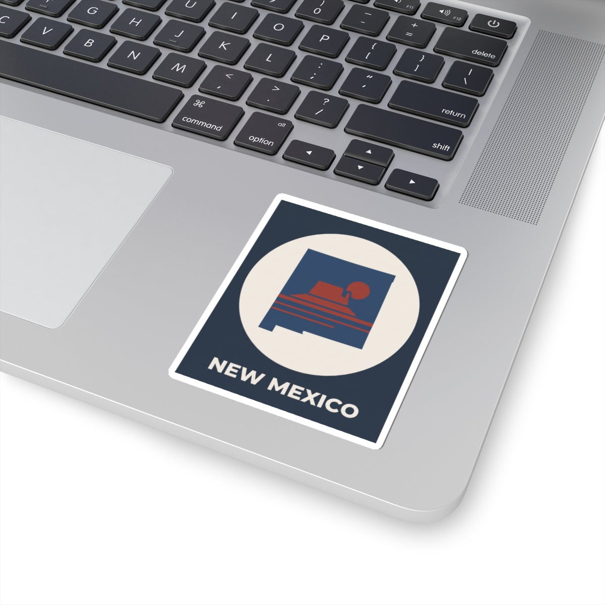 Angled New Mexico sunset kiss-cut sticker with white border, white circle, and “NEW MEXICO”.