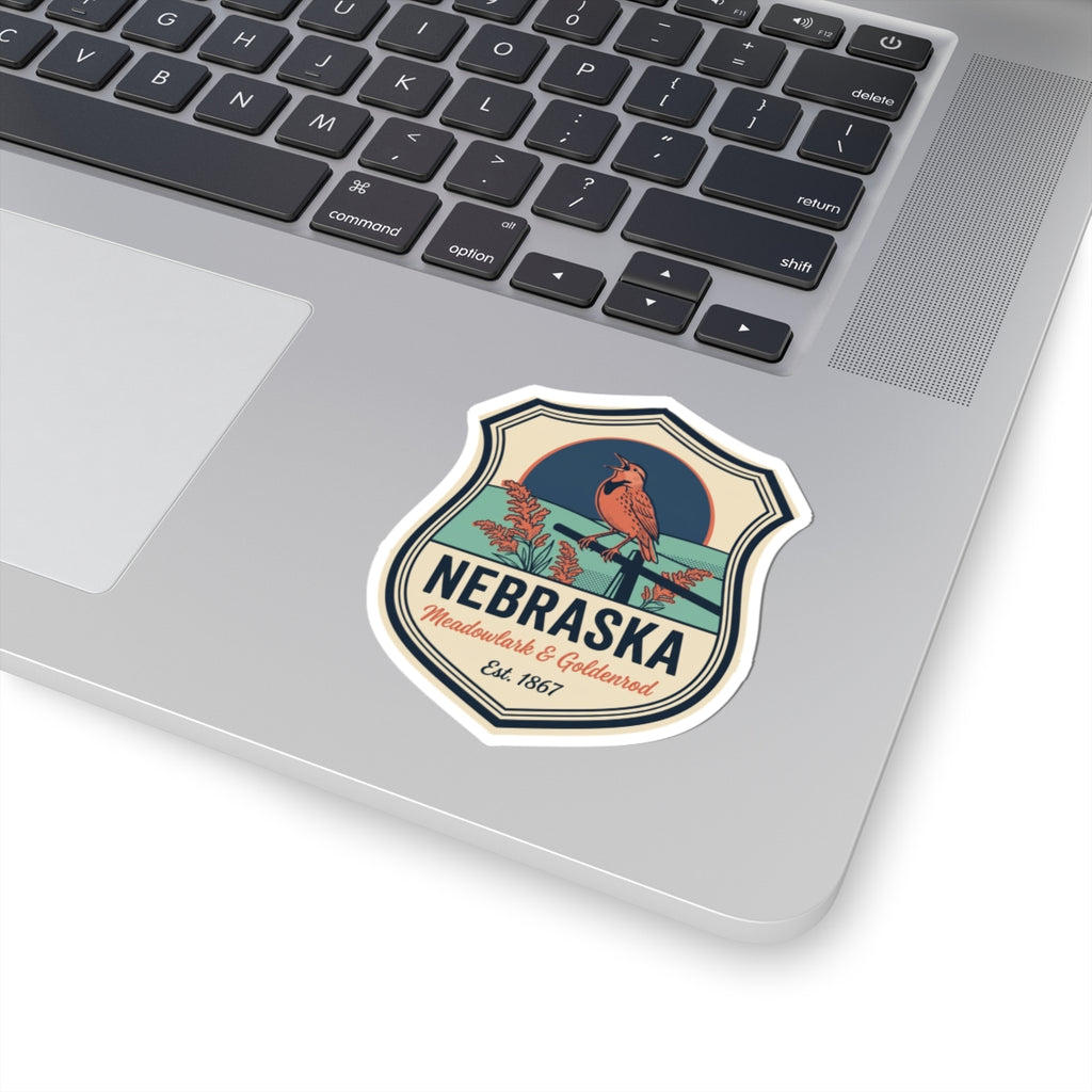 Nebraska vintage badge sticker on a laptop palmrest, meadowlark & goldenrod, Est. 1867