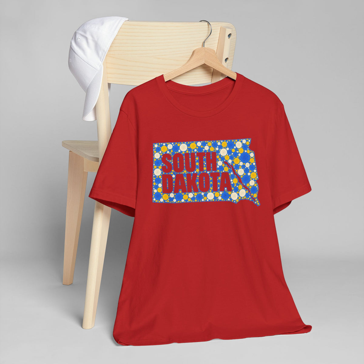 Red crewneck T-shirt with South Dakota polka-dot map graphic in blue and yellow.