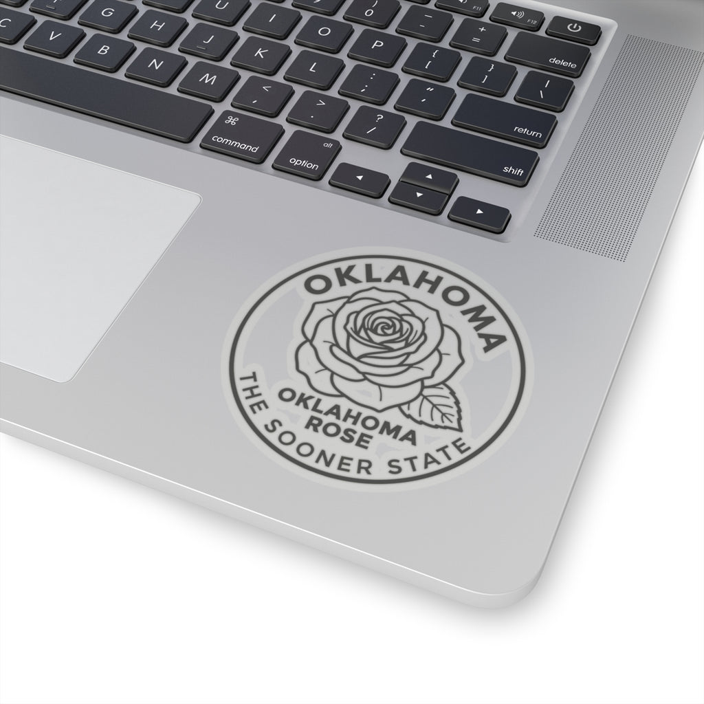 Transparent vinyl Oklahoma rose sticker on laptop lid, circular outline with rose and text ring