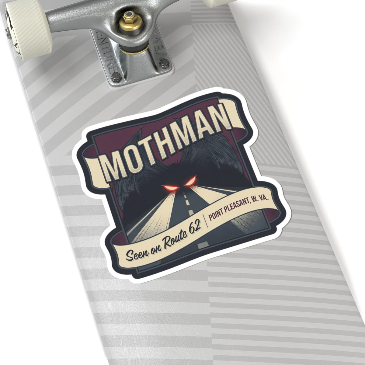 Mothman sticker on a gray-striped surface: red glowing eyes, road scene, Route 62 and Point Pleasant W.Va.