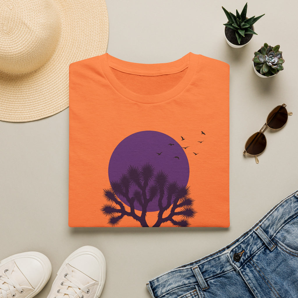 Orange crew-neck T-shirt with purple moon, silhouetted desert tree, and flying birds graphic
