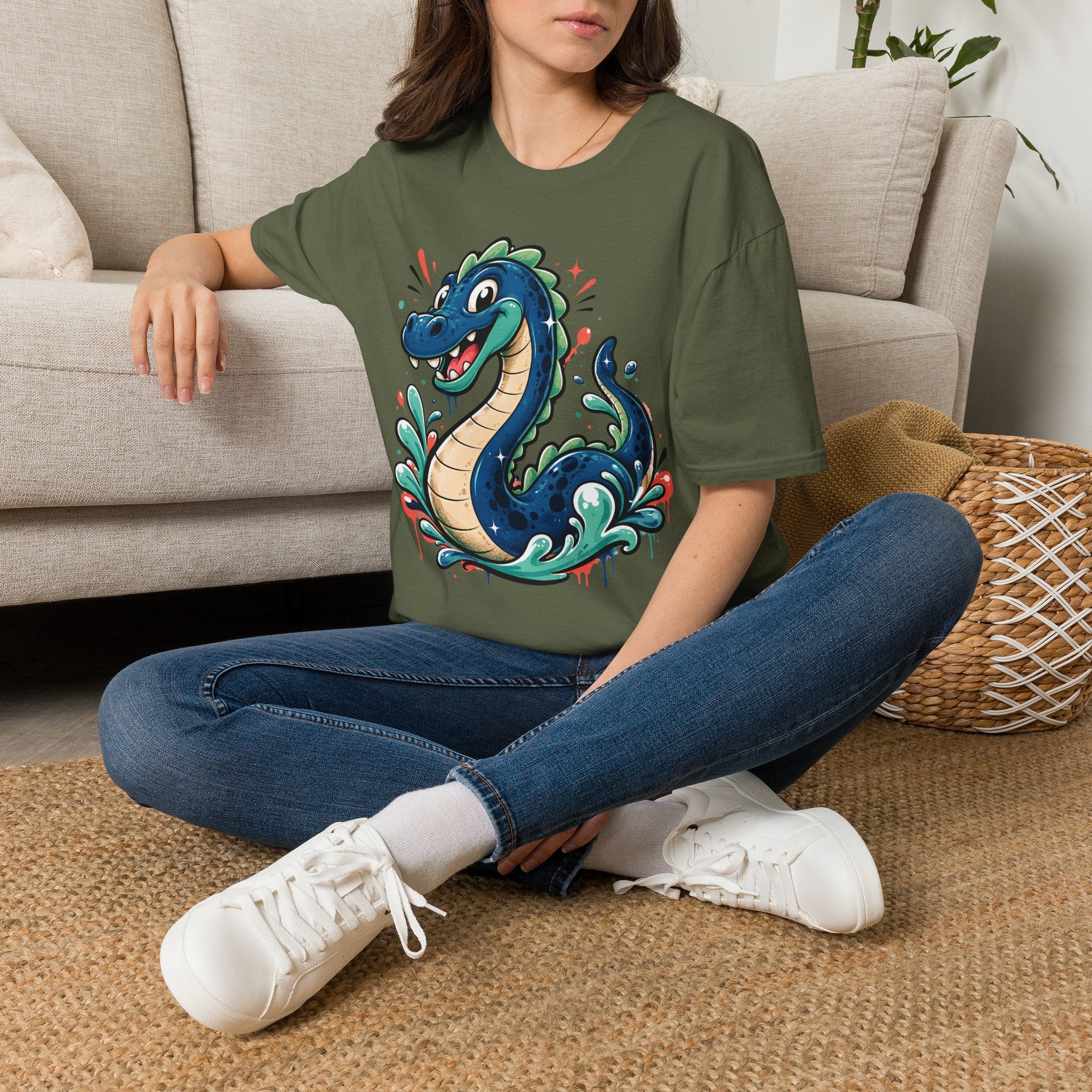 Olive green crewneck T-shirt with colorful cartoon sea serpent graphic on front