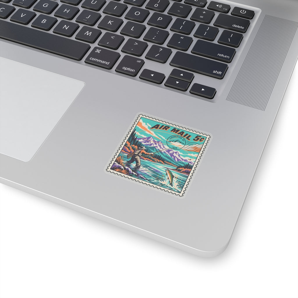 Air Mail 5c stamp-style vinyl sticker on a laptop lid, fisherman and mountain river art