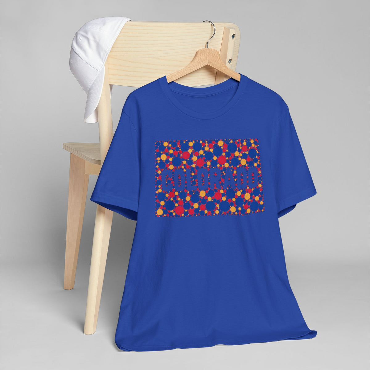 Blue crew-neck t-shirt with a multicolor rectangular patterned graphic on front.