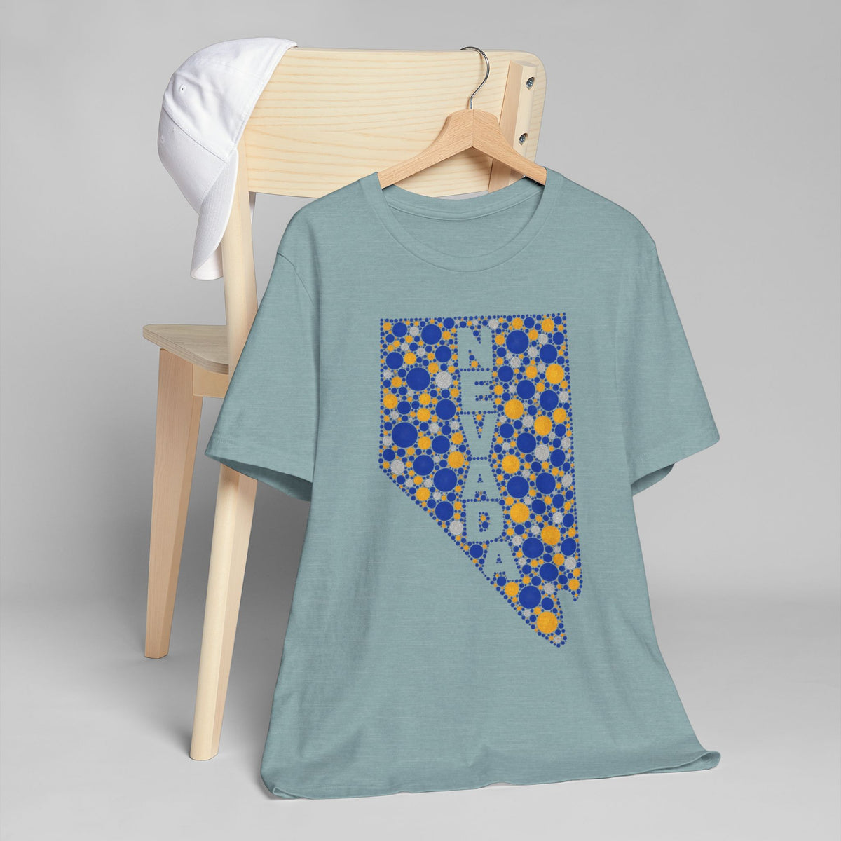 Light teal crewneck T-shirt with Nevada state floral dot graphic in blue and gold