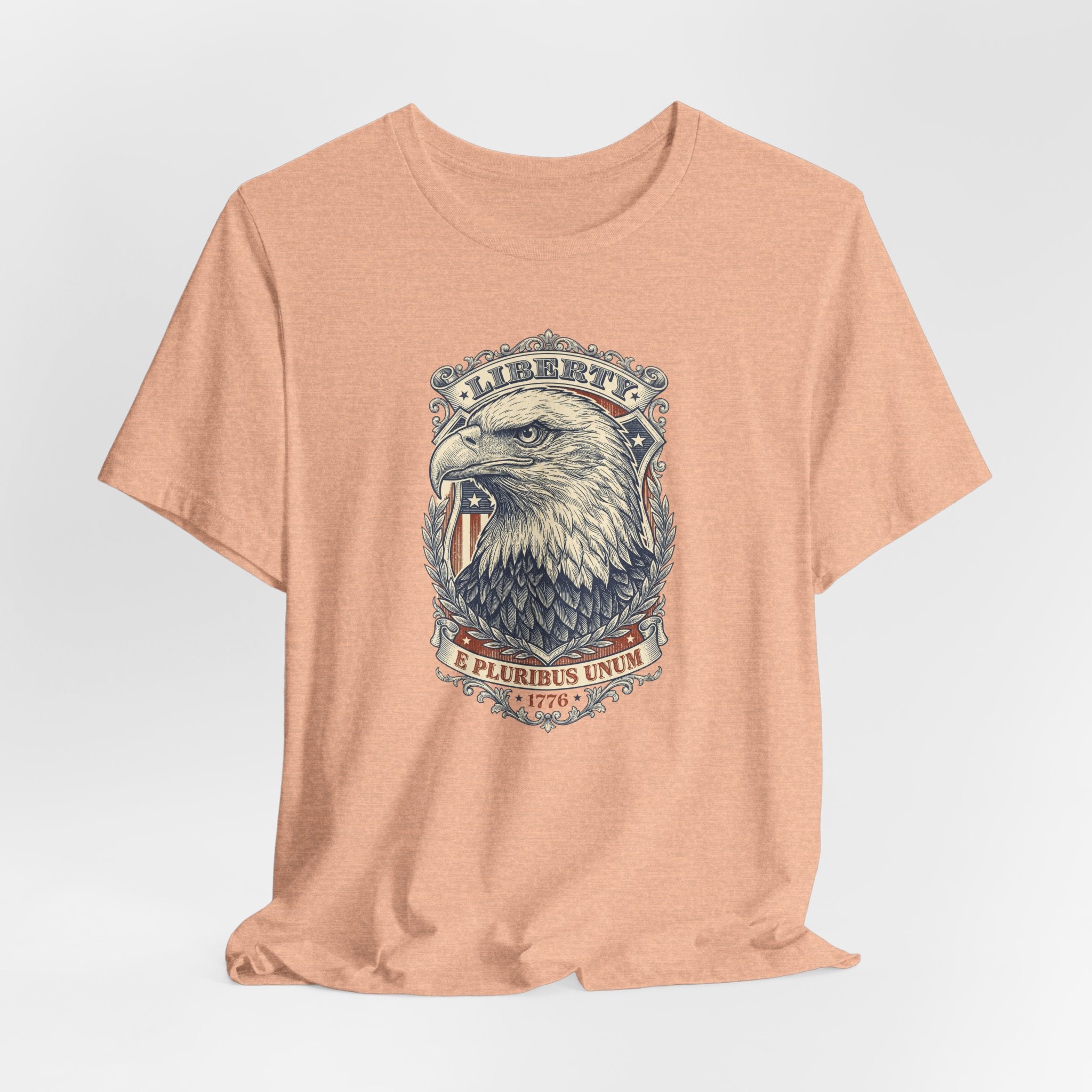 Peach crewneck tee with bald eagle head graphic centered on chest