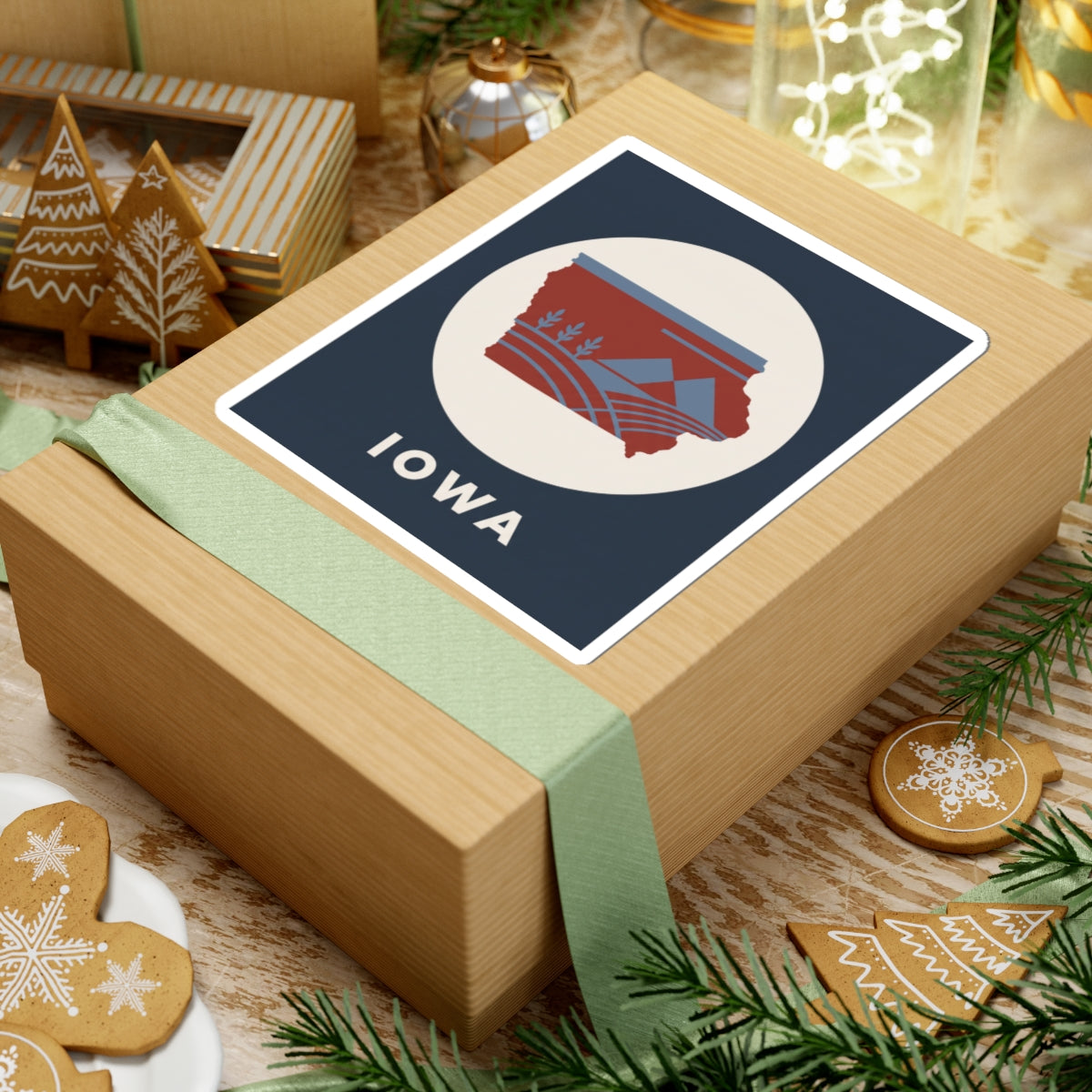 Square kiss-cut sticker with red Iowa map graphic, blue accents, and "IOWA" lettering