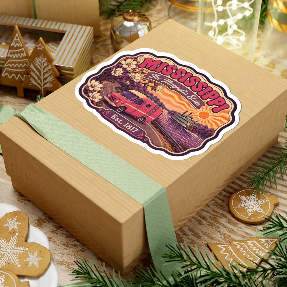 Mississippi state sticker on wrapped box, white outline; pink camper, magnolia blooms, sun