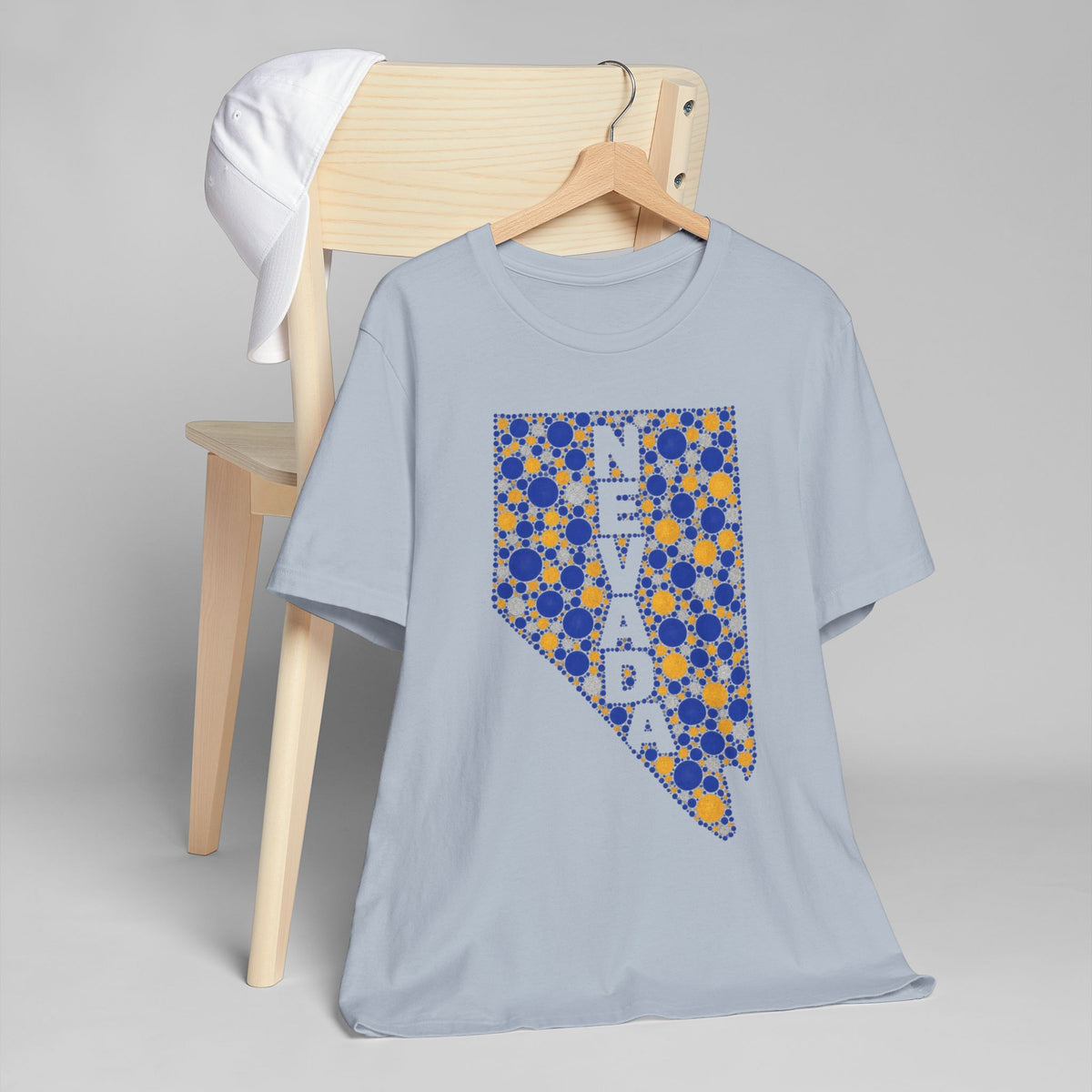Light blue crewneck T-shirt with Nevada state floral dot graphic in blue and gold