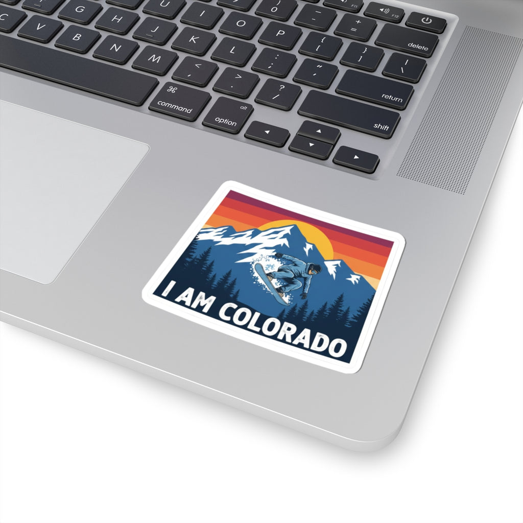 I AM COLORADO sticker on laptop surface, white border, snowboarder mountain graphic
