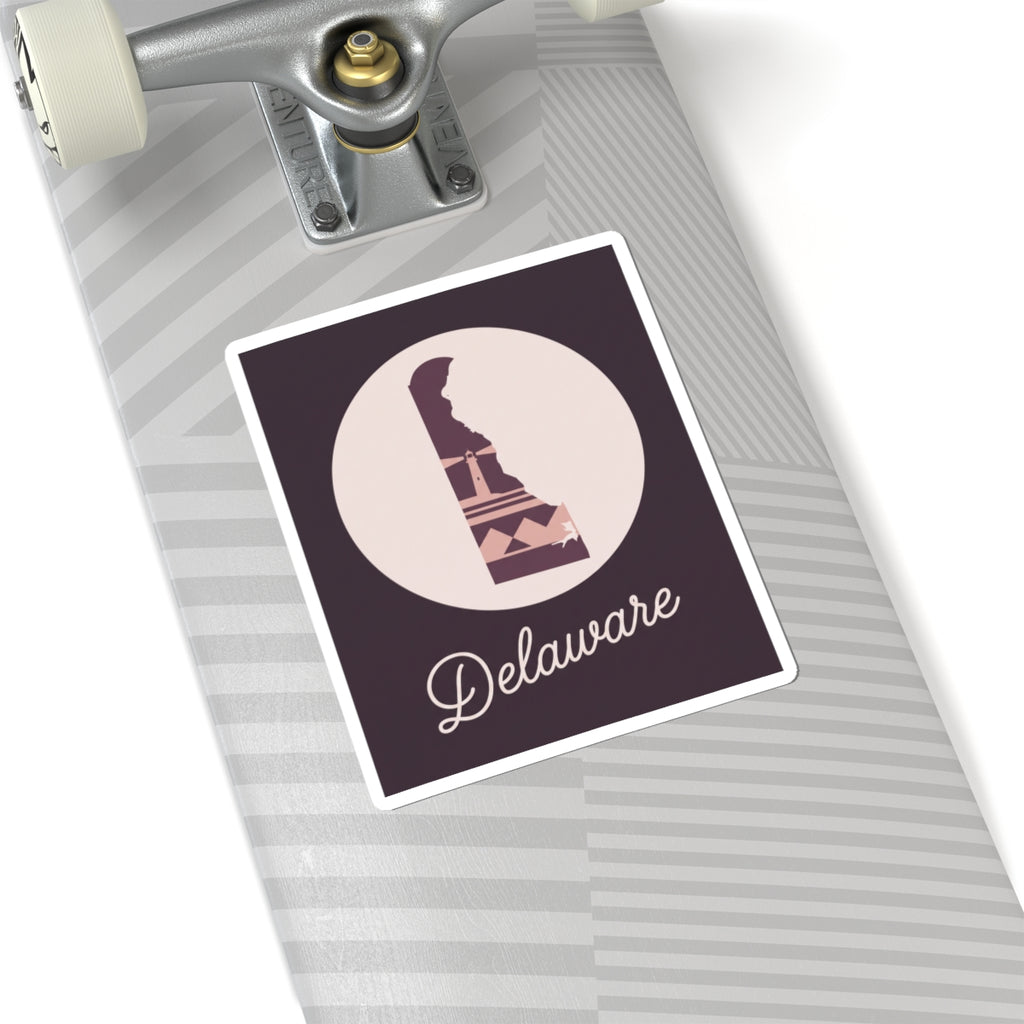 Delaware silhouette vinyl sticker on notebook, mauve lighthouse and 'Delaware' script on dark purple