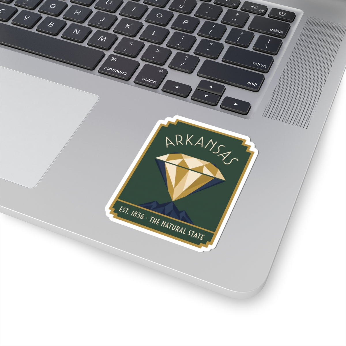 Arkansas diamond sticker placed on a laptop trackpad area