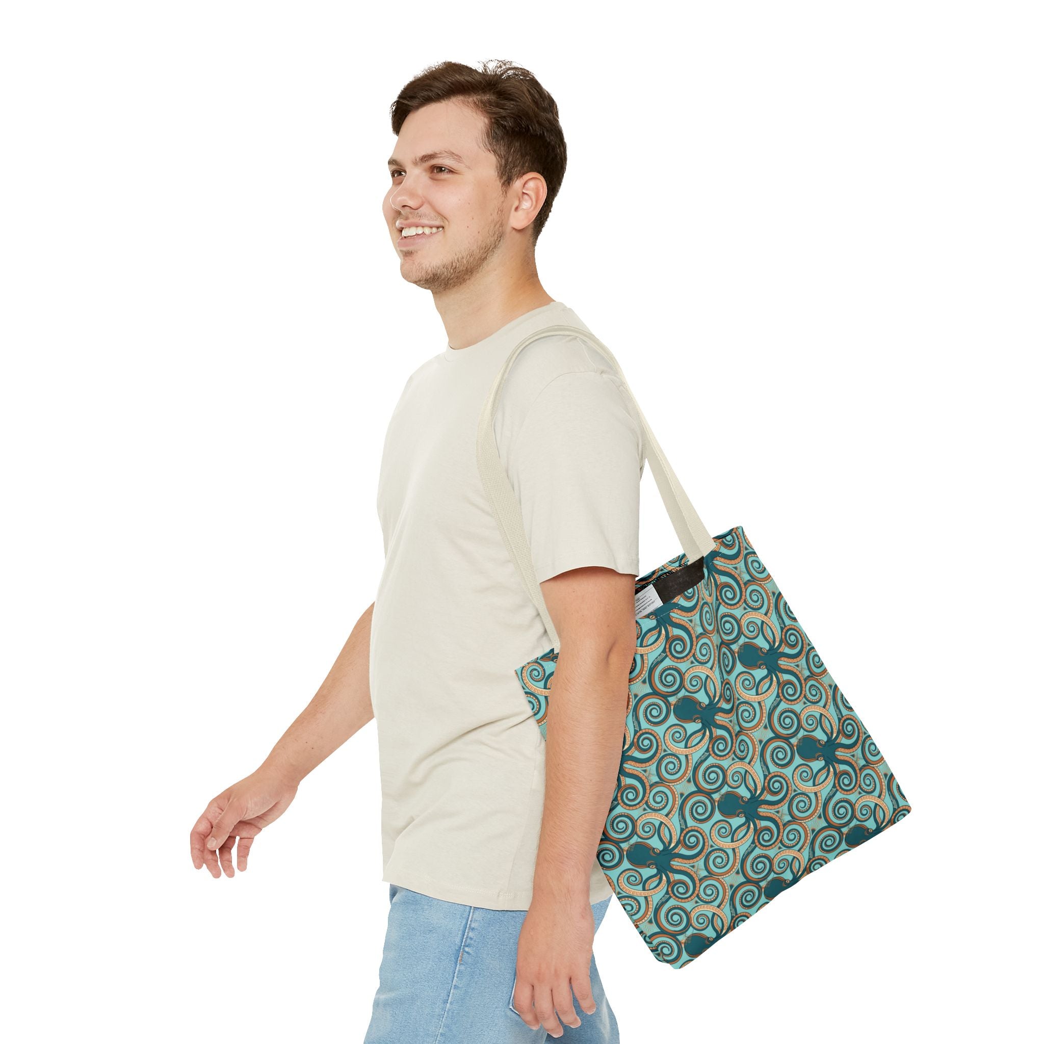 Teal octopus swirl tote bag with rope handles, carried at side.