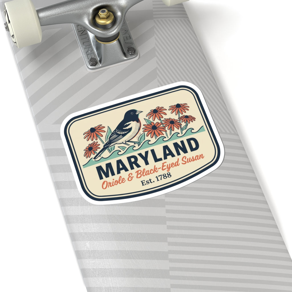 Maryland sticker on a light gray surface, rounded badge with blue bird and red flowers