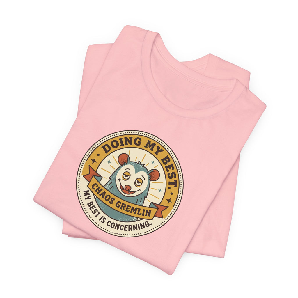 Light pink T-shirt with circular gremlin badge graphic, short sleeves, crew neck.