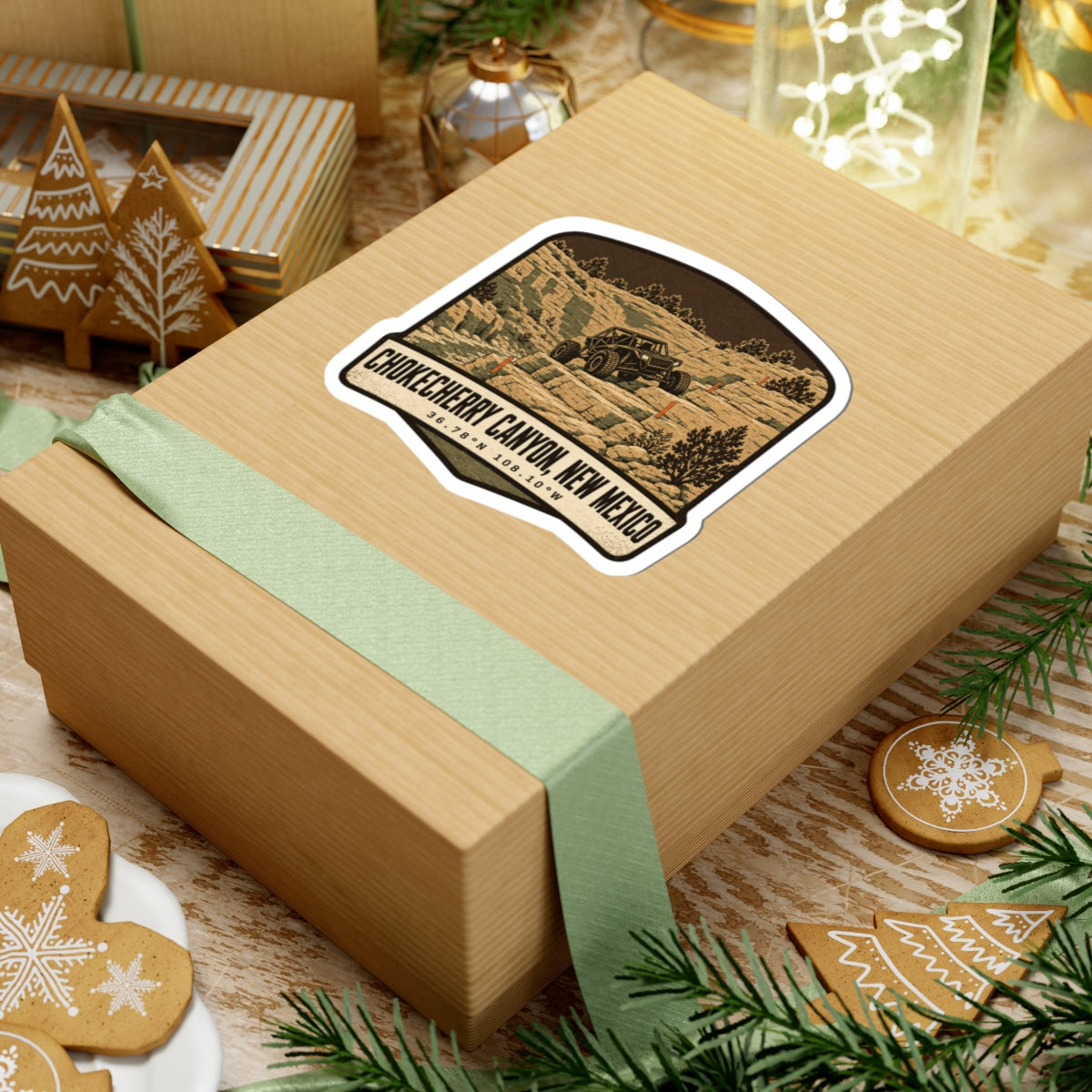 Die-cut sticker on a gift box with desert canyon off-road vehicle and 'Chokecherry Canyon, New Mexico'