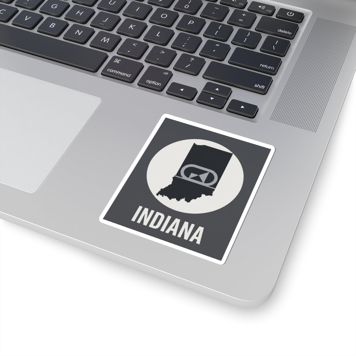 Indiana sticker on laptop, black-and-white badge emblem with “INDIANA” text