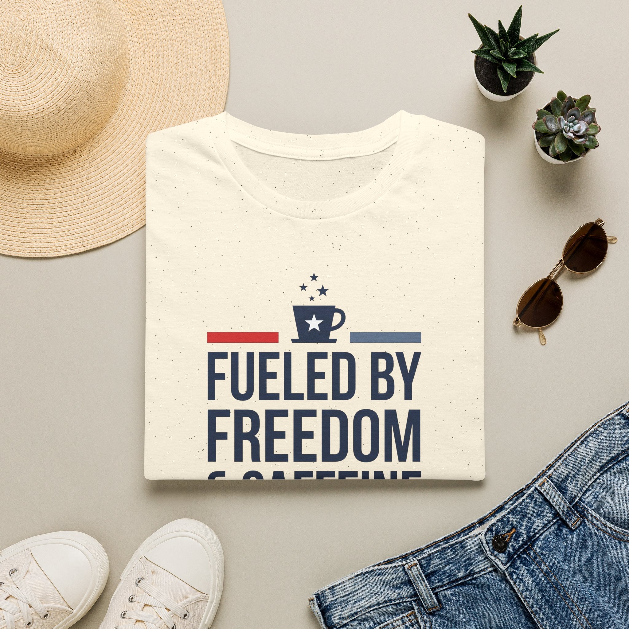 Cream-white unisex crew-neck T-shirt with front graphic reading “Fueled by Freedom”