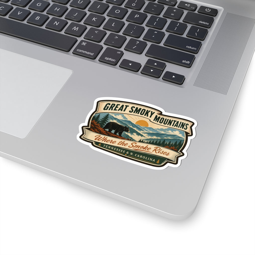 Great Smoky Mountains travel sticker on a laptop, retro bear-and-mountains badge; “Where the Smoke Rises”