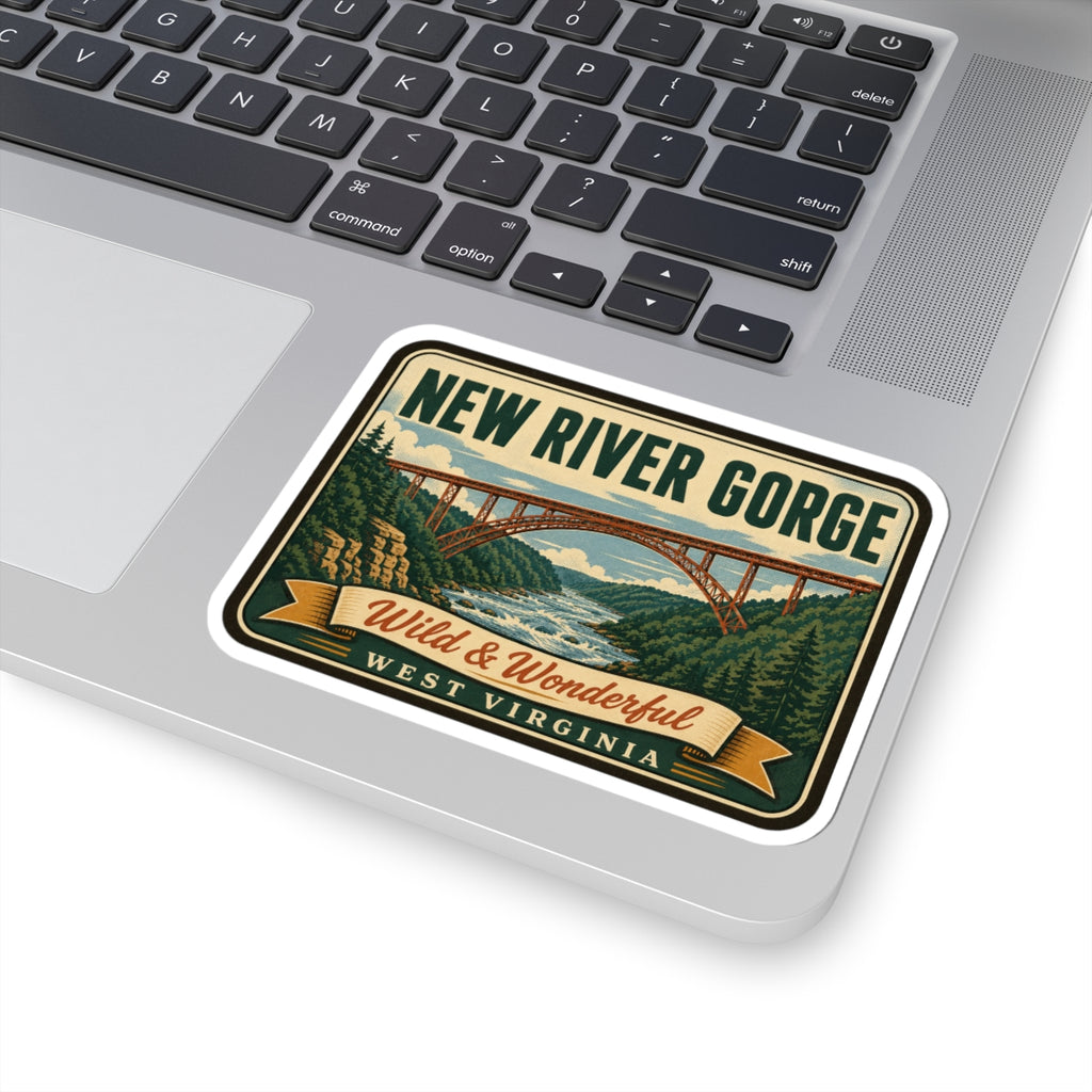 Travel sticker on laptop trackpad area showing New River Gorge bridge and Wild & Wonderful West Virginia