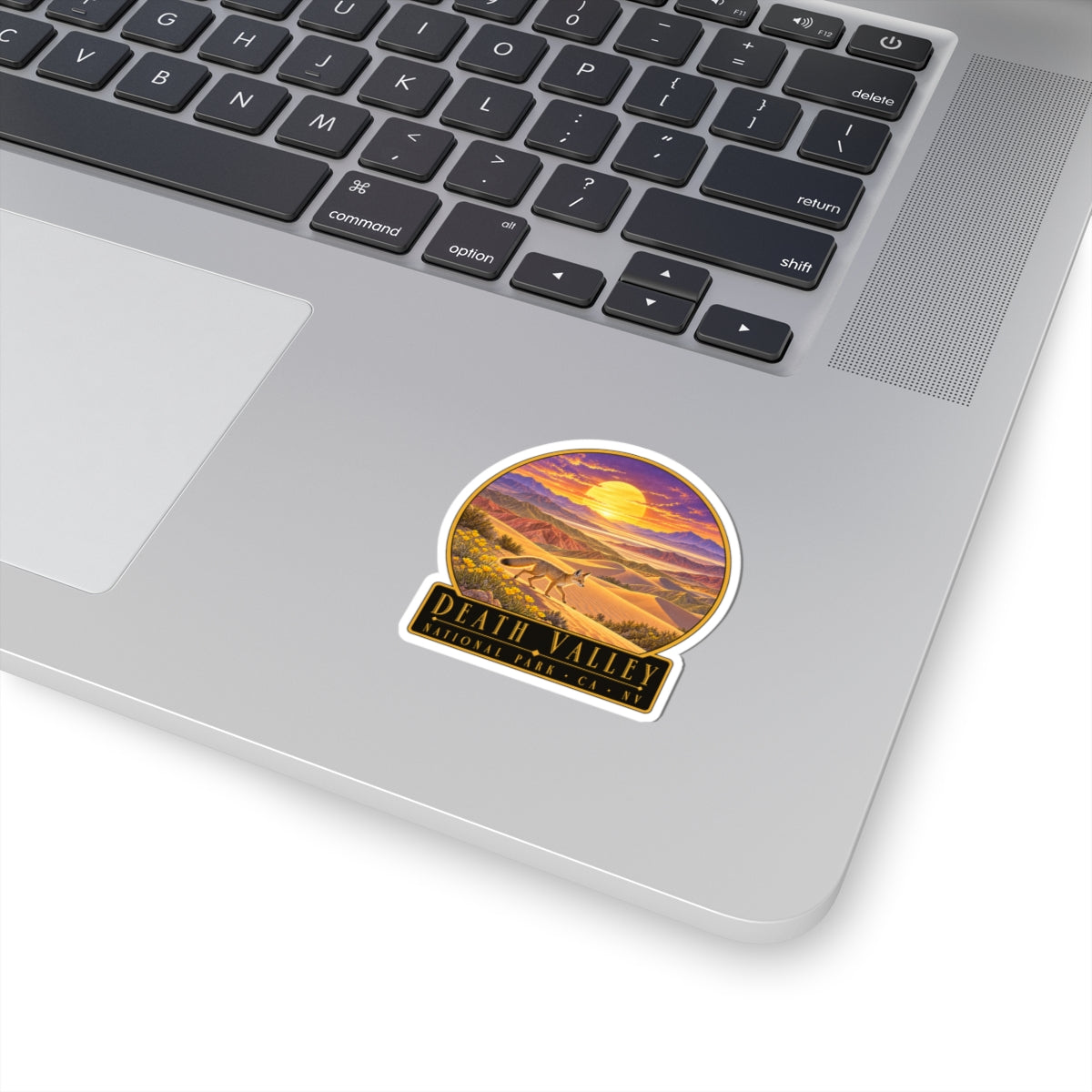 White die-cut sticker with Death Valley desert sunset landscape and text