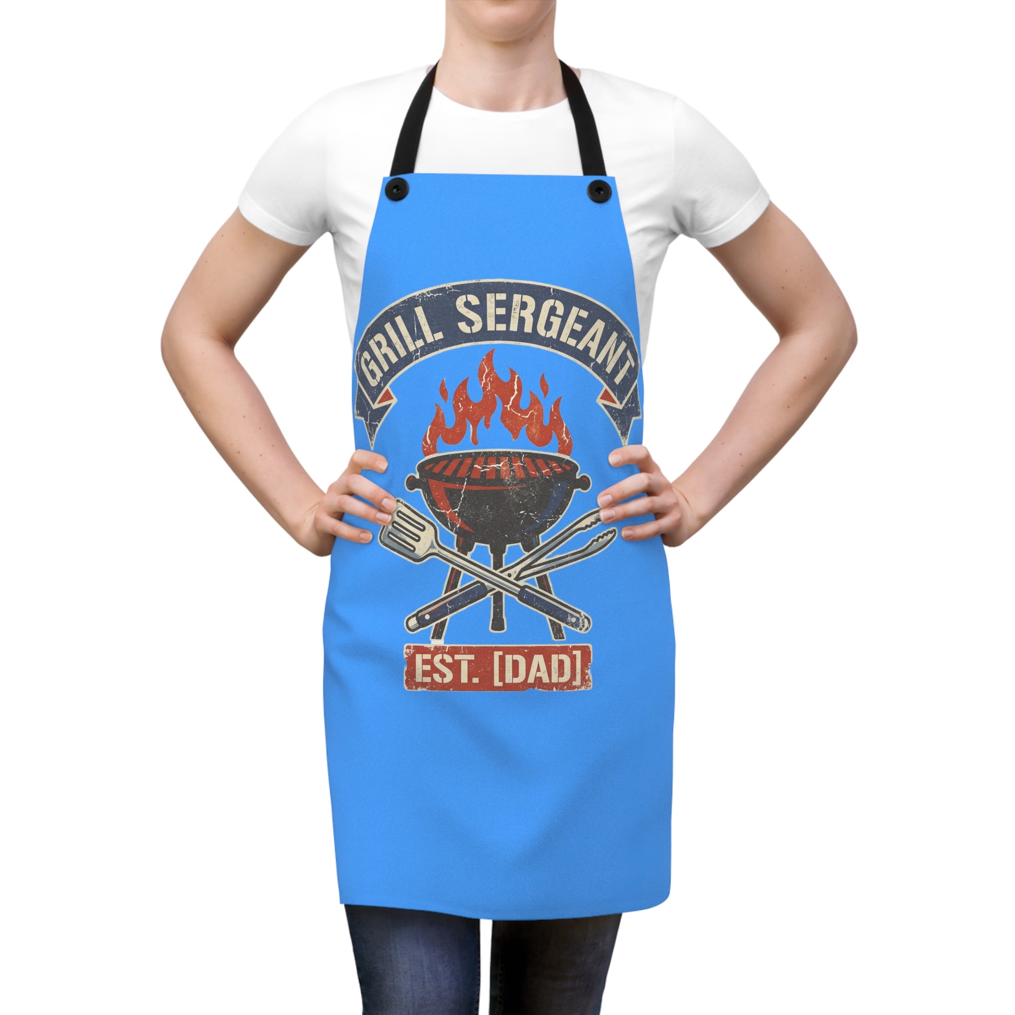 Blue grilling apron worn over white T-shirt with black neck and waist straps